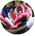pink white and blue flip flops in basket