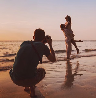 golden hour photo of groom lifting bride captured by honeymoon photographers