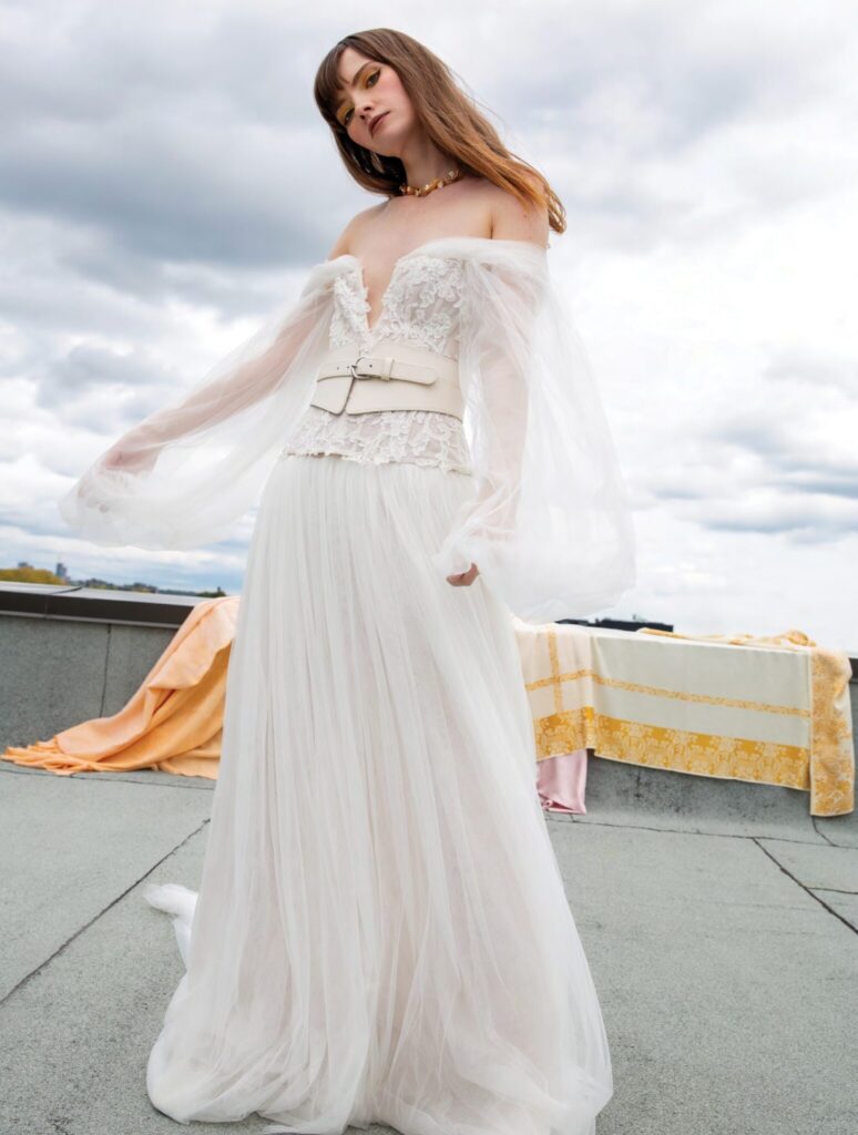 woman wearing off the shoulder vintage lace wedding dress with long sleeves free-spirited fashion dress