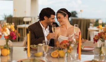 portrait of bride and groom sitting at recepton table at destination wedding