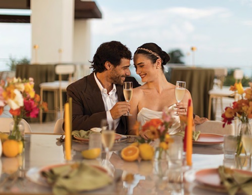 portrait of bride and groom sitting at recepton table at destination wedding