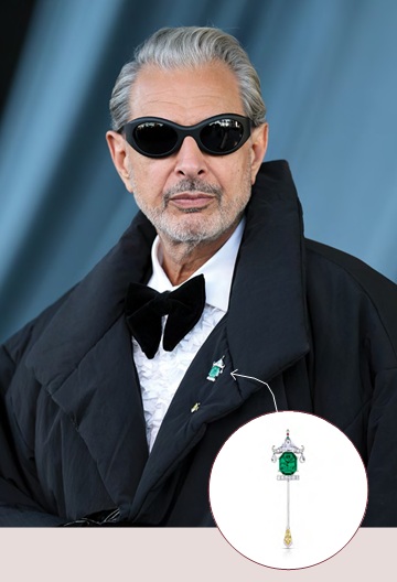 Jeff Goldblum wearing black tuxedo with emerald pin