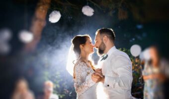 bride and groom dancing to first dance song at night next step after the wedding