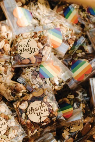 Assorted granola bars in clear wrappers with a round 'thank you' sticker and rainbow-striped labels.