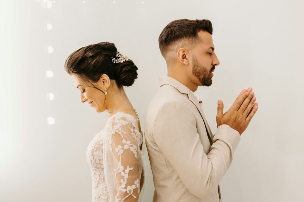bride and groom say a prayer for the perfect wedding after talking about wedding planning mistakes