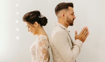 bride and groom say a prayer for the perfect wedding after talking about wedding planning mistakes ways to prepare for wedding spotlight
