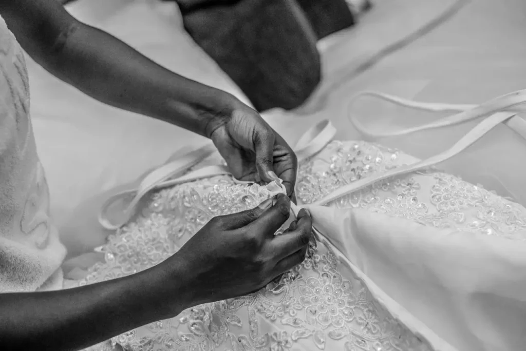 woman sewing wedding dress during wedding dress alterations