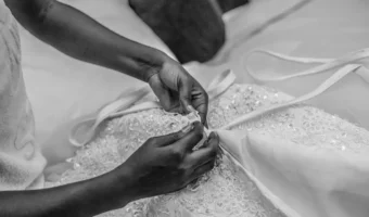 woman sewing wedding dress during wedding dress alterations