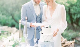 soft and airy photo of bride and groom at cake table after wedding cake questions answered