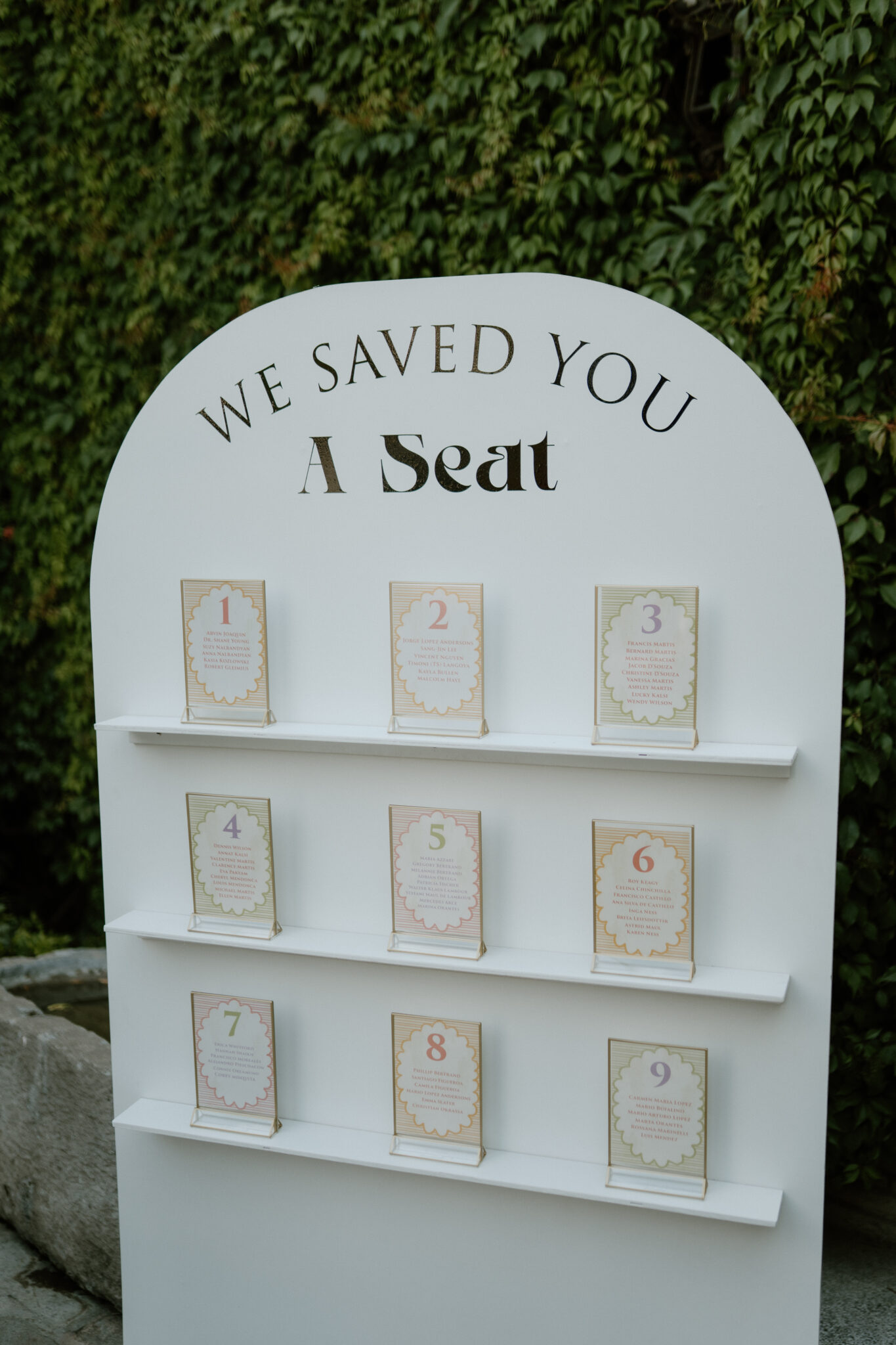 White display board with a curved top that reads 