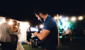 wedding videographer shoots bride and groom dancing