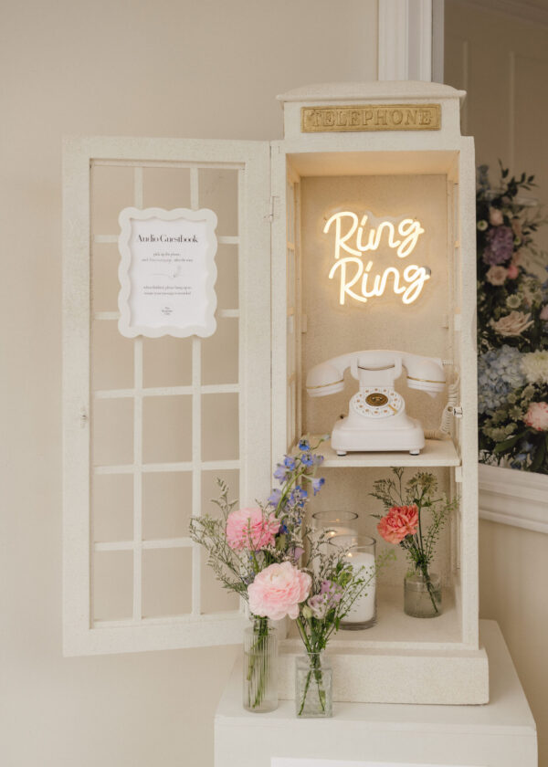 Vintage white telephone display with a neon 