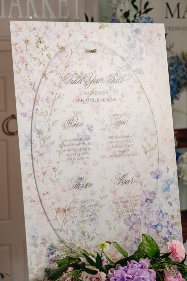Floral wedding seating chart for Vanessa's bridal shower on a pastel blossom backdrop with guest names from top to bottom.