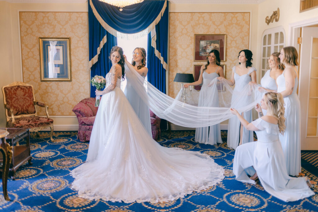 beautiful portrait of bride with bridesmaids in vintage room at Hotel Saskatchewan wedding 