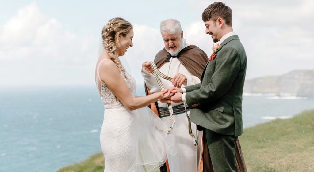 bride and groom handfasting ceremony at Cliffs of Moher