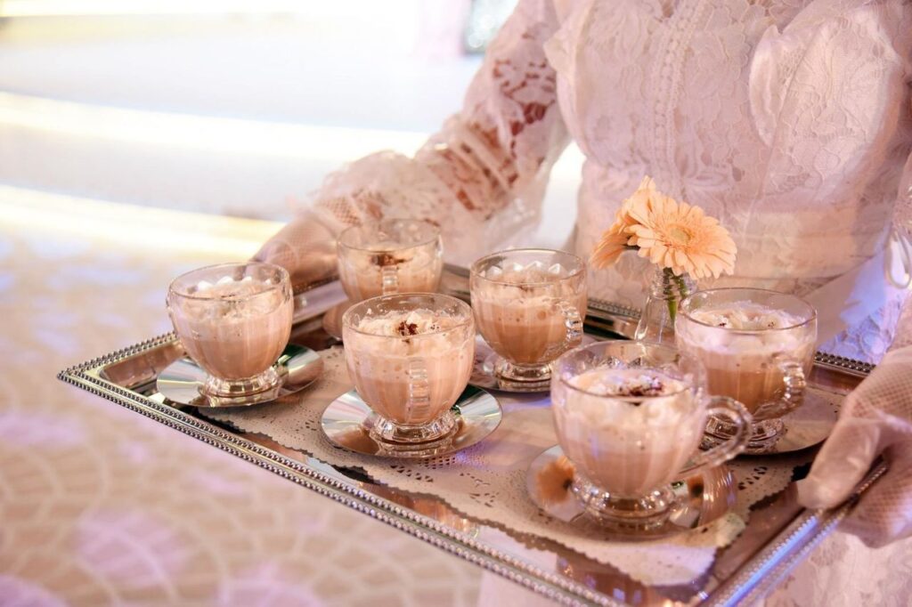 A woman carrying a tray of non-alcoholi beverages wedding drinks