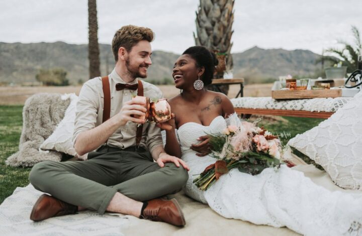 bride and groom sitting on lounger drinking non-alcoholic beverages