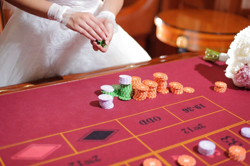 bride in wedding dress at roulette table betting instead of having photo booth
